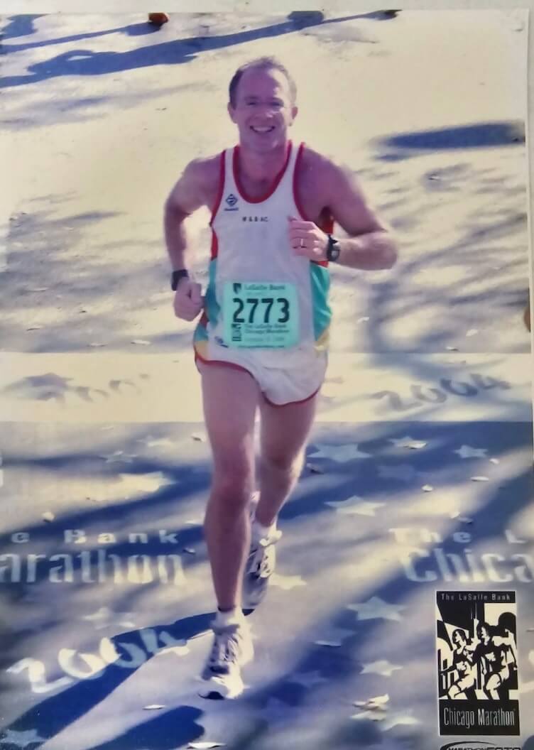 Jeff smiling while crossing the finish line at the 2004 Chicago Marathon